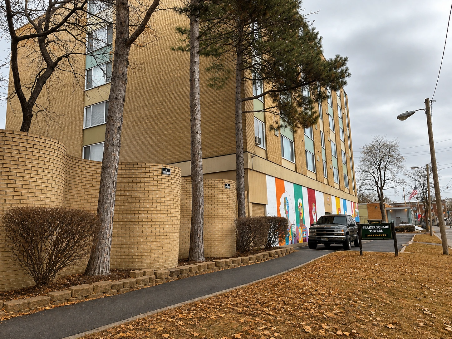Tree-lined entrance to Shaker Square Apartments in fall